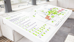 the audiotactile map of the tu dortmund university campus. legends as well as streets and buildings are shown tactilely. labels in braille and pyramid letters.