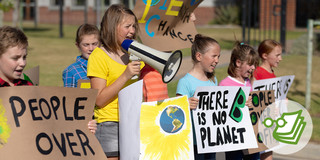 Seven children demonstrate for the environment and sustainability with posters and megaphones.