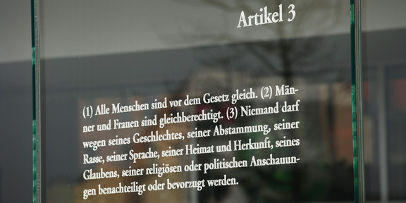 Article 3 of the Basic Law on the equality of men and women is written on a glass plate, taken on April 3, 2016 in Berlin's Mitte district in the government quarter. According to Article 3, no one may be discriminated against because of their race, origin or political views.