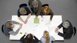 five students and a professor sitting aroung a table