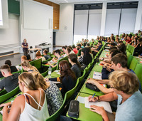 Students sit in a lecture at the beginning of the study.