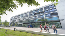 One of the engineering buildings with students in front of it.