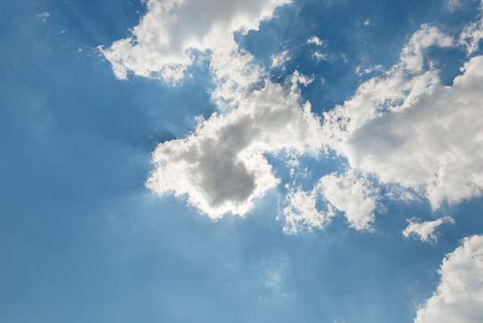 A blue sky with small white clouds.